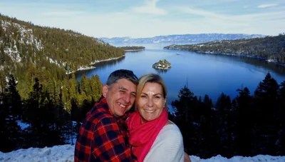 Travelers smiling at Emerald Bay overlook in South...