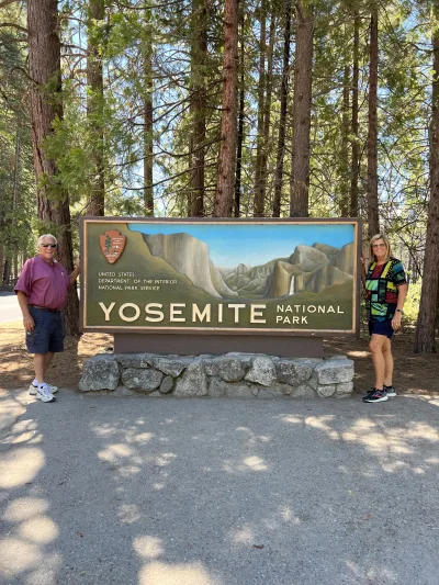 Guests at the Yosemite National Park entrance sign